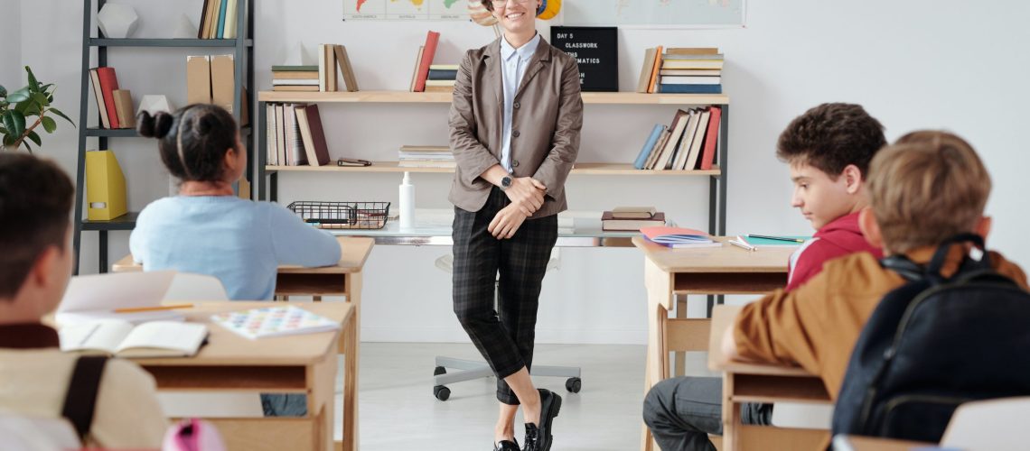 Teacher smiling in classroom with students